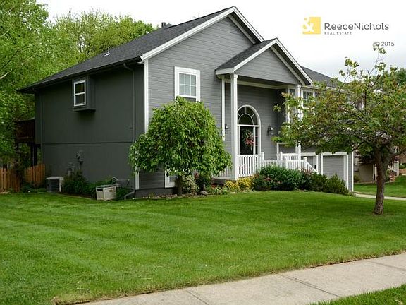 Level side yard leads to green space.