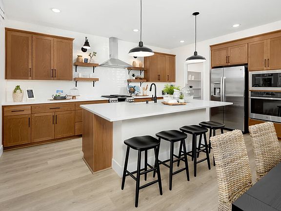 Kitchen with pendant lighting and floating shelves