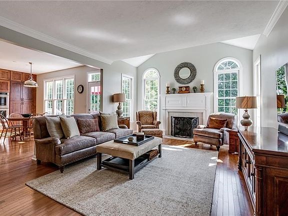 What an outstanding open floor plan!  The warm and welcoming family room boasts fireplace framed by an elegant mantle.  Floor to