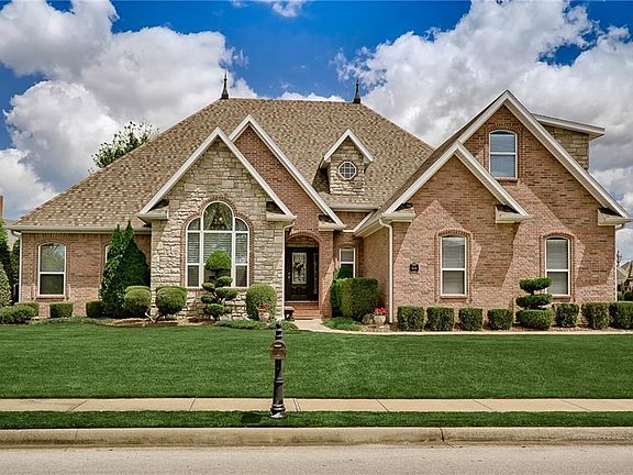 Gorgeous elevations - brick framed windows, arched entrance & a beautiful mix of brick and stone make this curb appeal extra special...