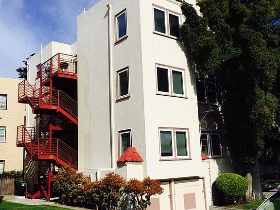 back of building with balcony visible at top floor