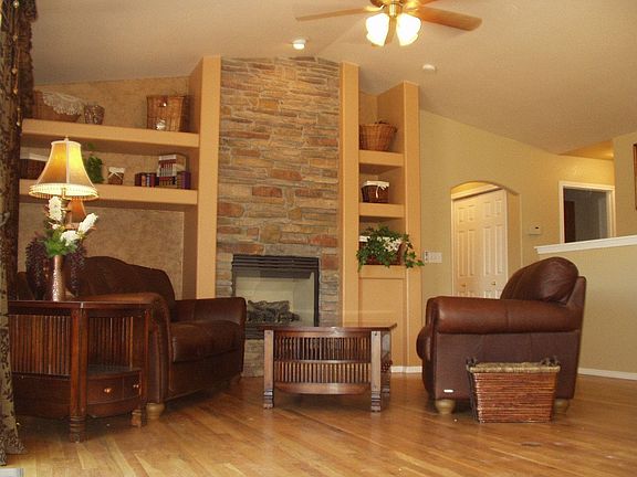 Great room with floor-to-ceiling stone gas fireplace and built-ins