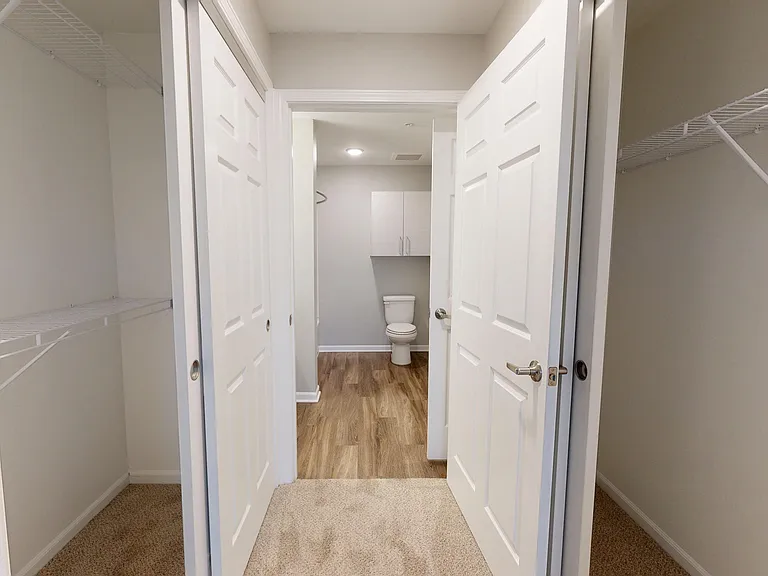 The Redbud's primary bedroom features a walkway with double closets and direct access to the bathroom. The Redbud's primary bedroom features a walkway with double closets and direct access to the bathroom.