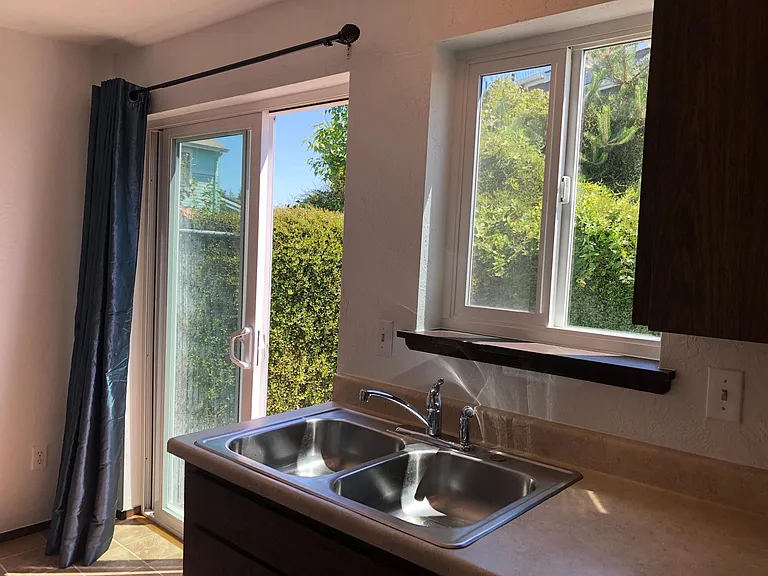 Kitchen area looks out at private fenced patio area