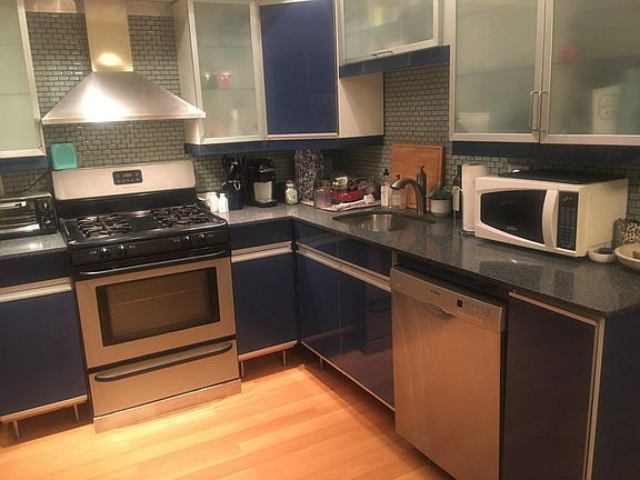Kitchen with glass tile and granite counters