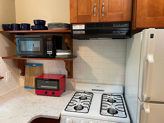 Propane range, microwave, toaster oven, crock pot, cookware.