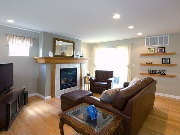 Gas fireplace and beautiful oak mantel elegant tile and hearth