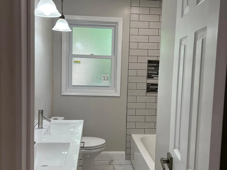 Stylish full bath with tub/shower combo serving the additional two bedroom
