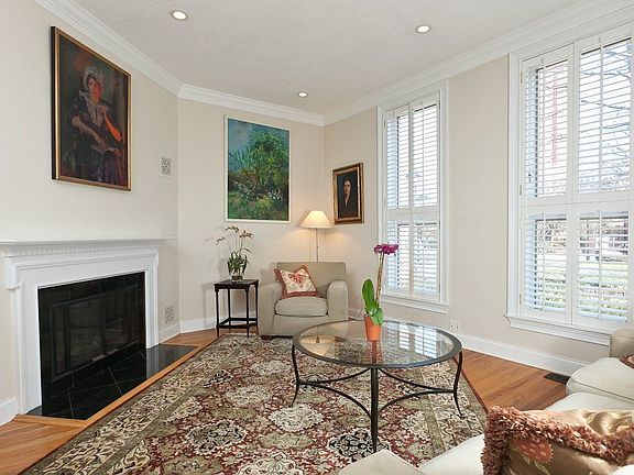 Living room with wood-burning fireplace and recessed lighting
