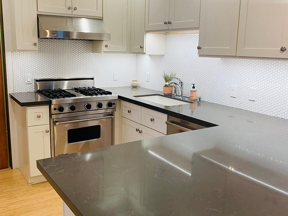 Fully renovated kitchen with high end appliances and quartz countertops