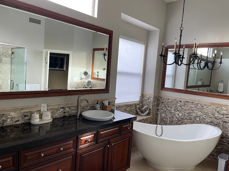 primary bathroom with separate shower and soaking tub