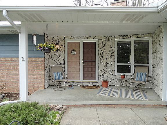 This gracious covered front porch stands ready to welcome both you and your guests!