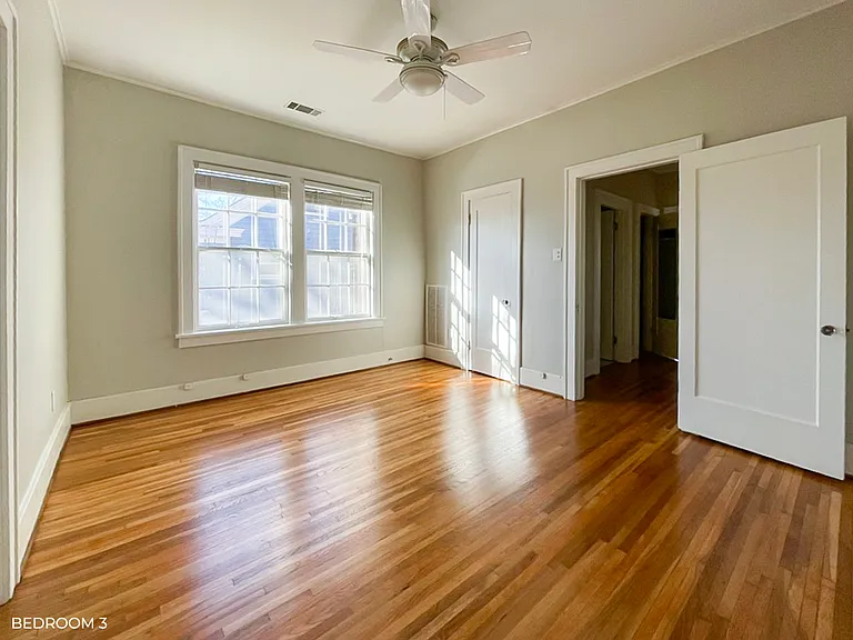 Bedroom with closet and ceiling fan.
