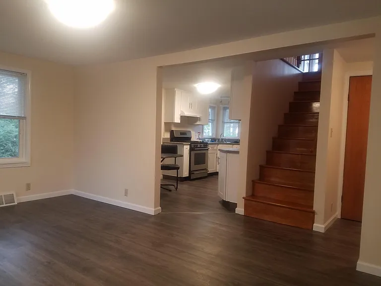 living room looking into kitchen &stairs to 2nd floor