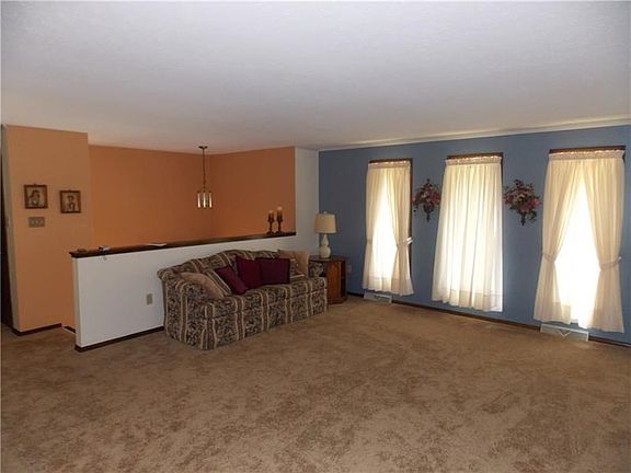 Enter the foyer and up a few stairs to the living level.  Newer wall to wall carpet in neutral colors and windows that allow for