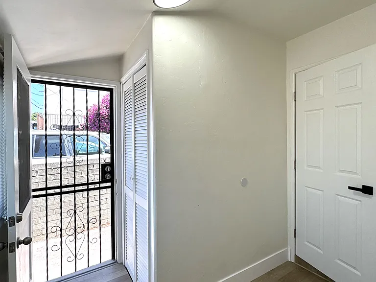 Small bonus room with additional closet/storage space and second entry/exit door.