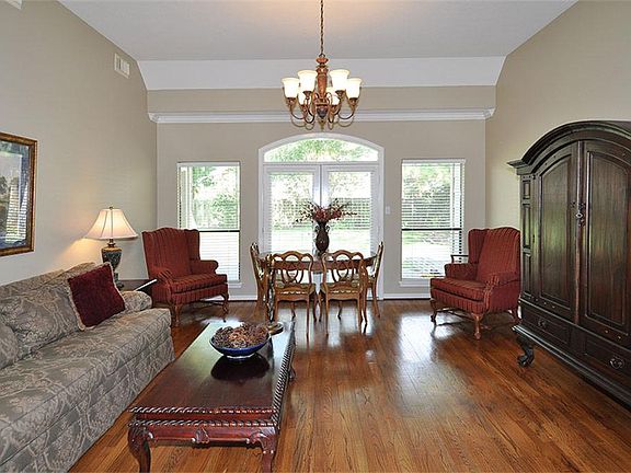 Formal living - on the back on the home with wood floors and lots of light for viewing the back yard...