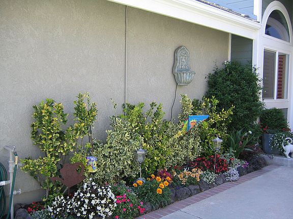 The sidewalk is bordered with flowers and lawn to reflect your creative taste.