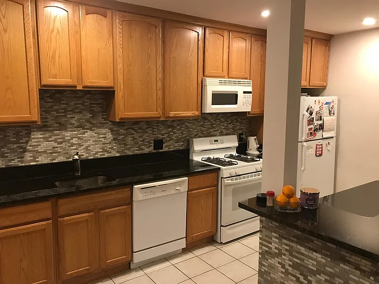 Open floor plan- furnished kitchen with cookware and silverware, furnished island with bar stools