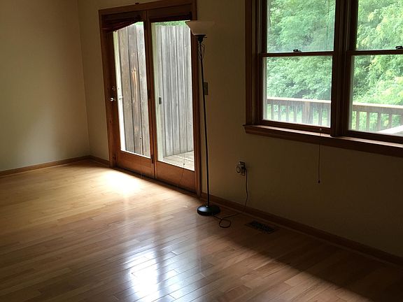 Living room with double doors leading to the back deck and backyard for a potential BBQ/gas grill.
