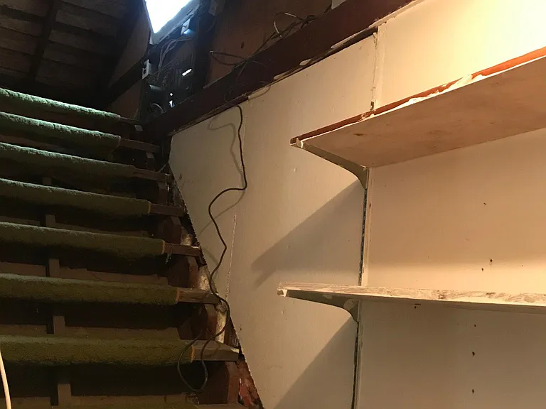 Stairs to Attic space with ample storage. NOT temperature / climate controlled.
