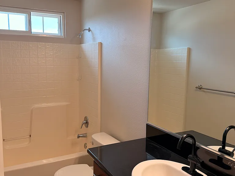 Guest bath shared among 3 bedrooms with updated fixtures and granite countertops.