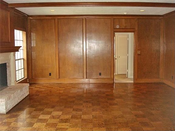  Large family living area with fireplace and parquet flooring.  Master is beyond family room.