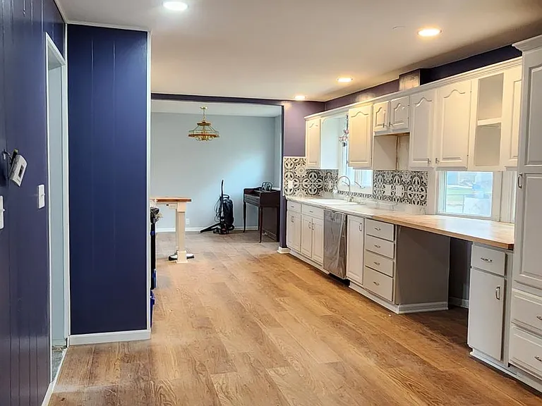 A view of the completely renovated large kitchen from the spacious den. ALL NEW APPLIANCES.