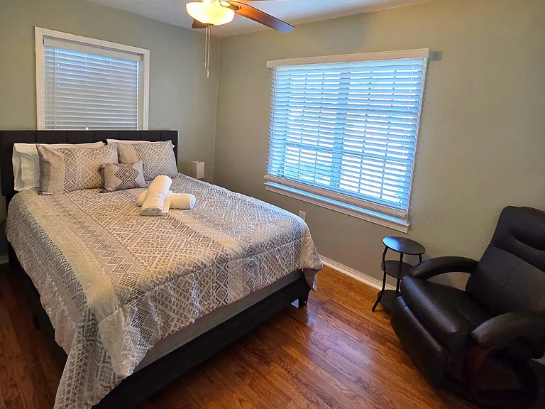 Bedroom with ceiling fan and accent chair for extra comfort