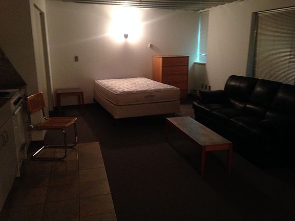 View of mattress, bedside table, and dresser