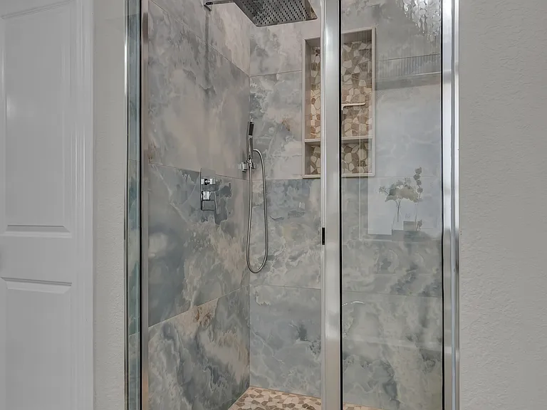 Master bathroom shower redesign 2024 with a rainfall showerhead, hand hand-held sprayer, and tiled ceiling to floor