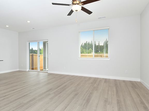 The family room is spacious with a ceiling fan.