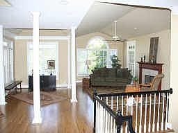 OPEN LIVING RM W/ FIREPLACE, HARDWOOD FLOORS AND A PIANO AREA W/ TREY CEILING