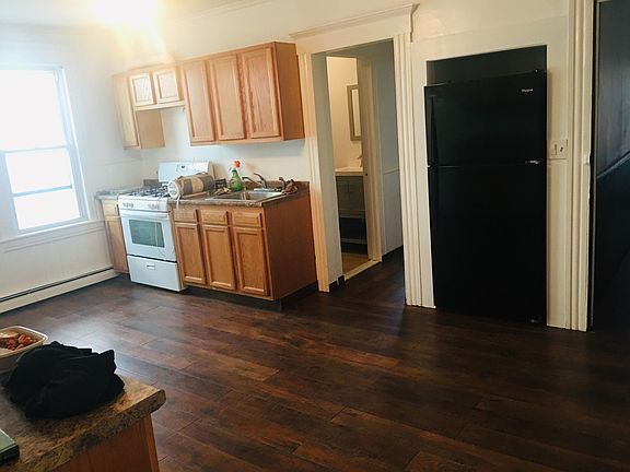 Kitchen cabinets, stove, sink, and fridge