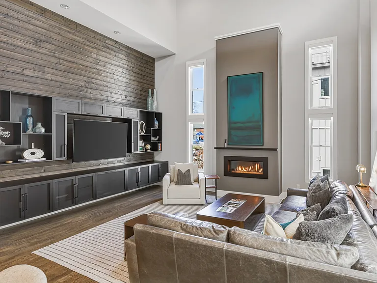 Bright, modern living room with HUGE ceilings. Abundant natural light, plush seating for everyone, a cozy gas fireplace, and a Smart TV_perfect for relaxing.