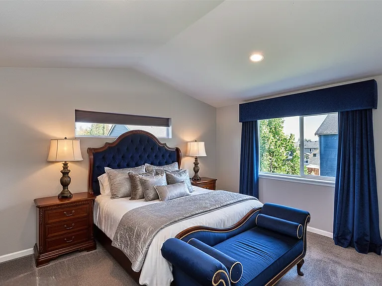 Expansive master bedroom with vaulted ceiling.