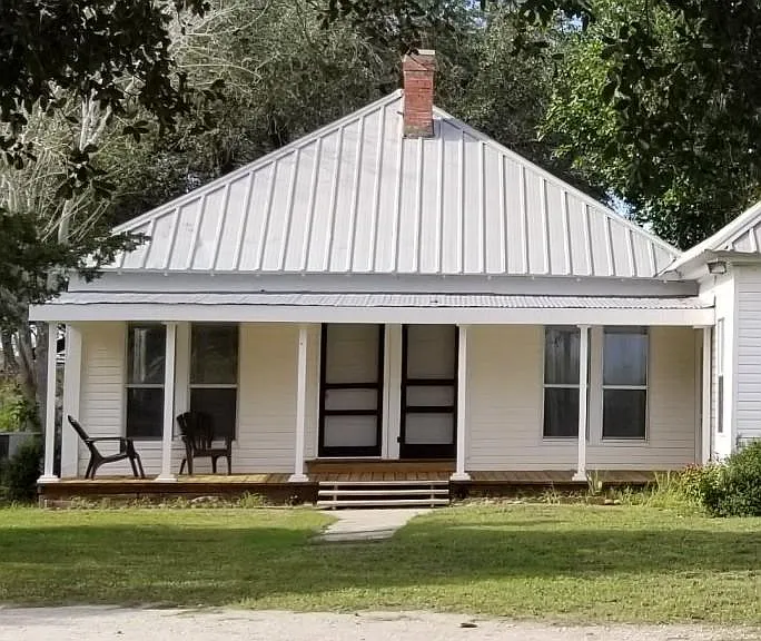 Wooden front porch, perfect for a porch swing and enjoying breezes.