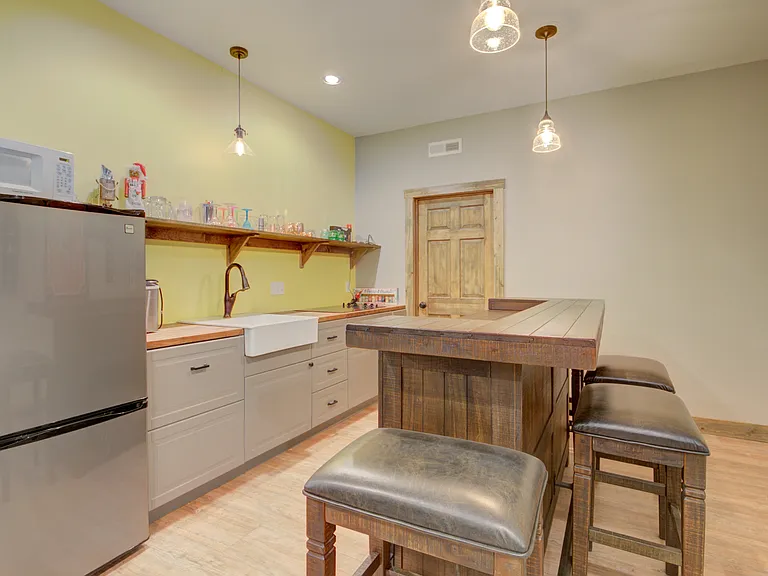 Basement kitchen area with bar seating.