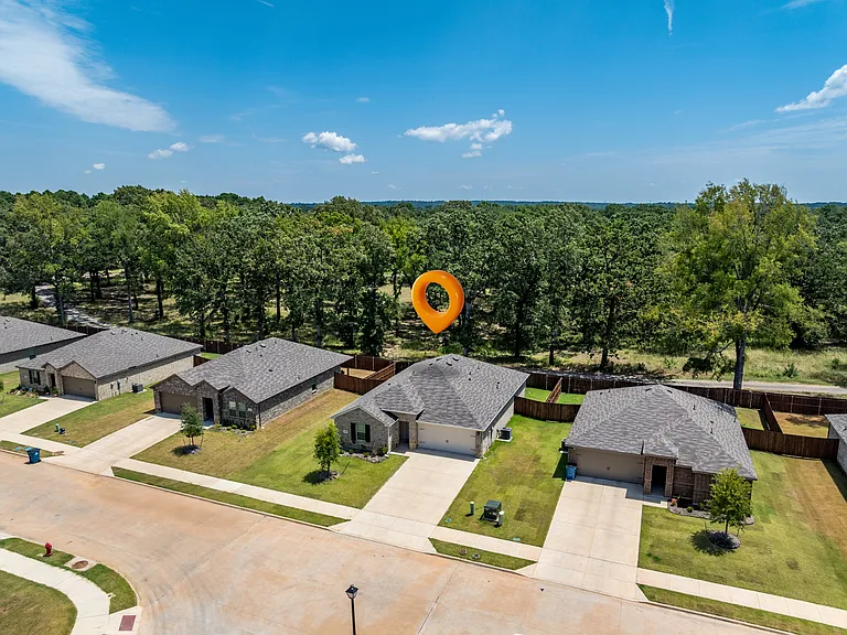 Home is located on a quiet street in the back of the neighborhood overlooking a heavily treed country estate.