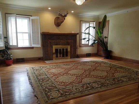 Large livingroom with crown molding, south facing windows, and pristine oak floors. Fireplace works!