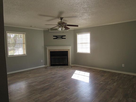 Living Room with corner fireplace, new paint.