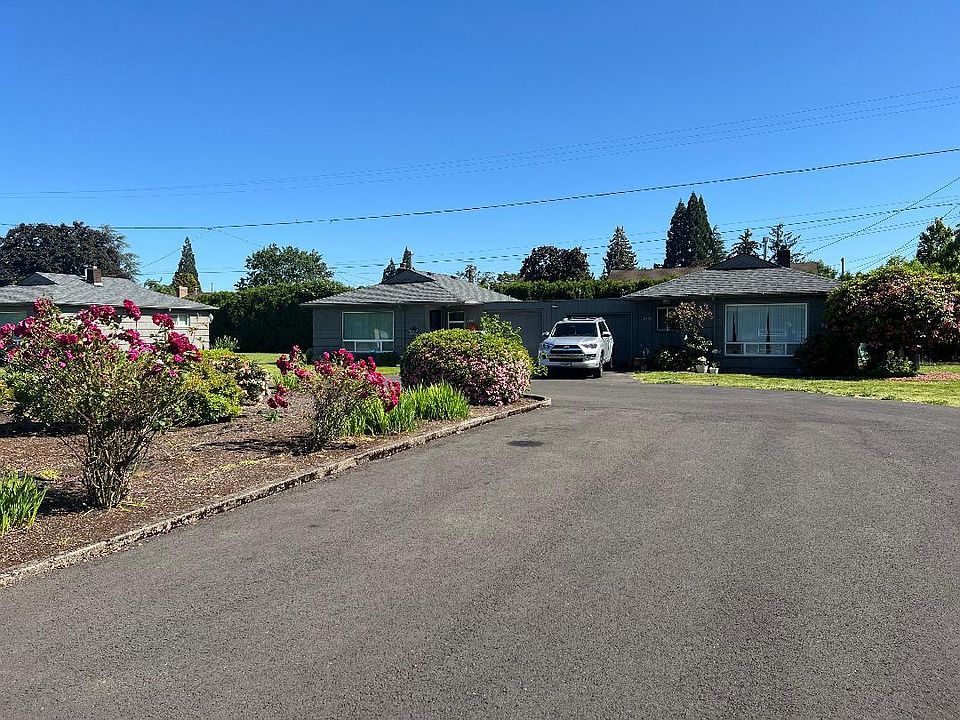 exterior of apartment. Parking in front of garage and inside of garage