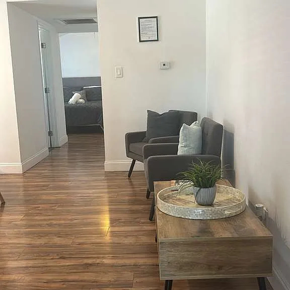 Inviting living room with comfy chairs, decorative cushions and elegant decor.
