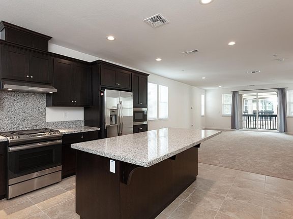 Recessed lighting kitchen opens to spacious living room