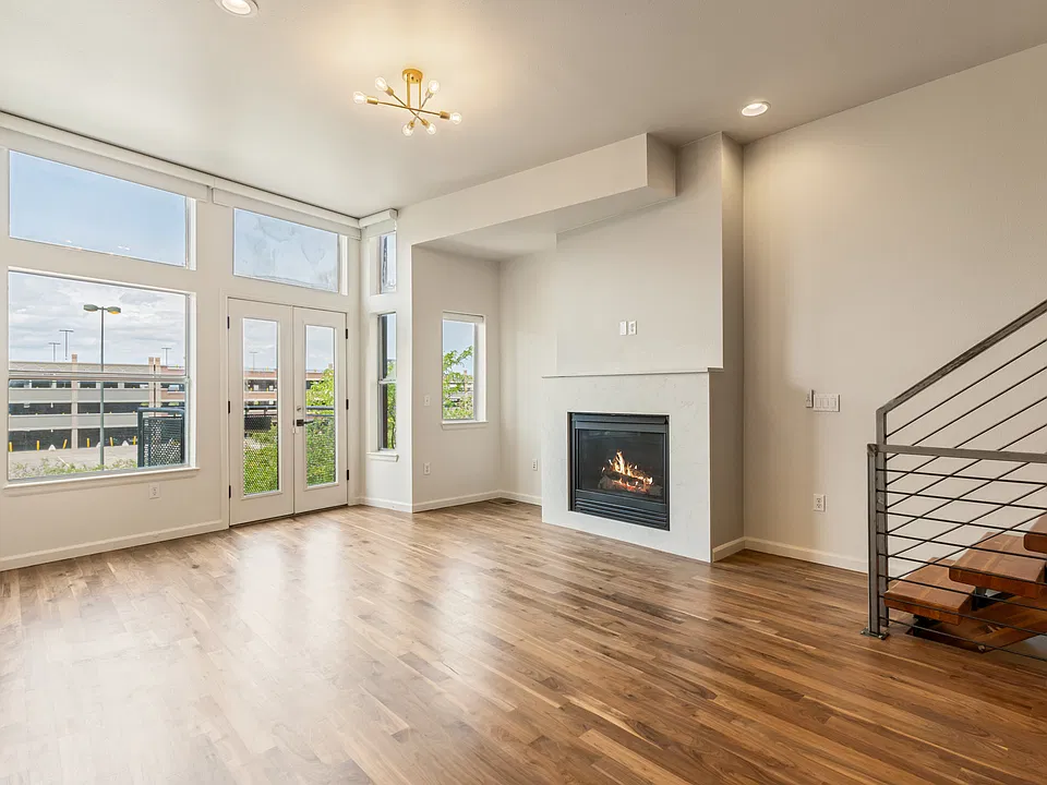 living room with gas fireplace & electric floor to ceiling blinds