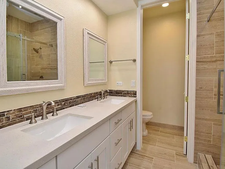 Upgraded master bathroom with dual vanity, recessed lights and bluetooth speaker in-built into exhaust fan