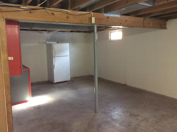 Large partially unfinished basement good for storage, workroom, or play area.