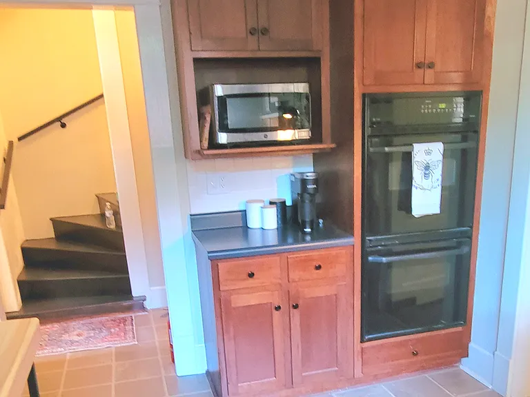 Double wall oven , microwave shelf and coffee bar area, with stairs leading to large 464 square foot upstairs bedroom / sitting area
