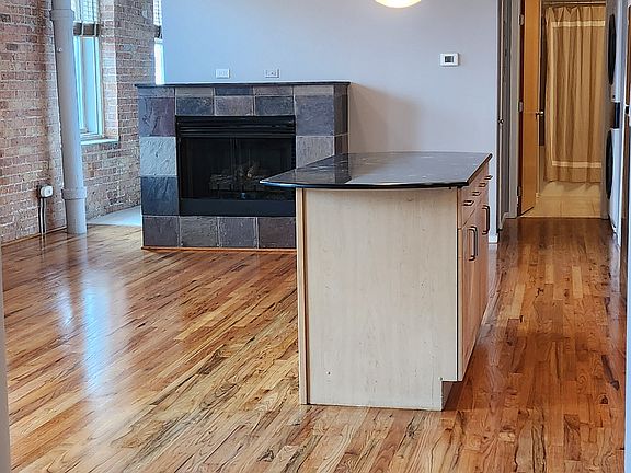 Beautifully refinished hardwood floors greet you at the entry to the unit