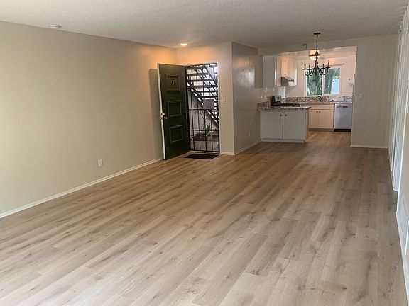 Living room view to front door, dining room and kitchen